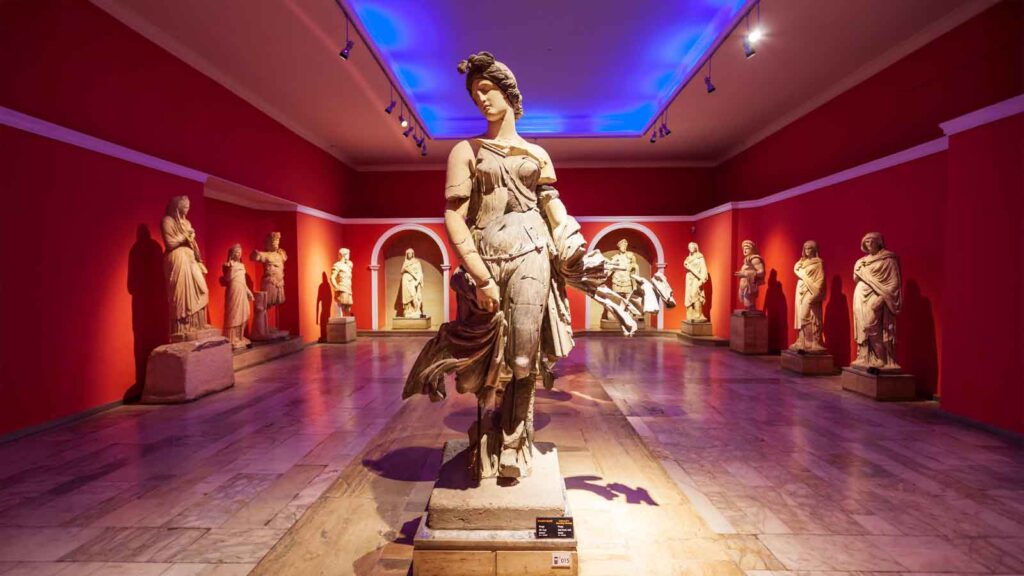 Interior of Antalya Museum's Roman statue hall displaying ancient marble sculptures and artifacts from Perge and Aspendos