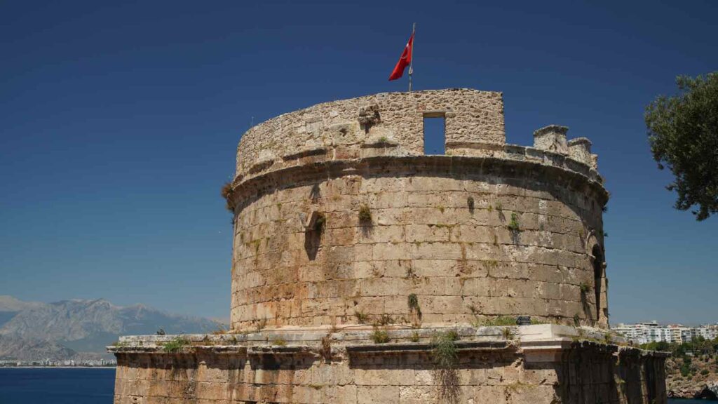 Ancient Hıdırlık Tower stone watchtower overlooking Mediterranean Sea with Karaalioglu Park gardens and coastline views