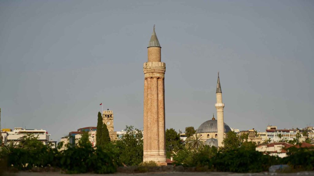 Yivli Minaret's distinctive fluted tower and red brick dome, iconic 13th-century Seljuk landmark of Antalya against blue sky