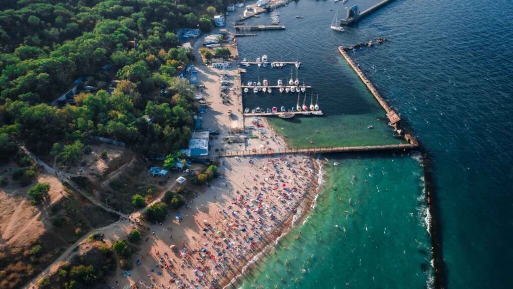 Antalya Marina with traditional gulet boats and modern yachts docked in turquoise waters surrounded by cliff-top restaurants
