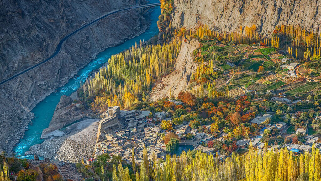 Panoramic view of snow-capped Rakaposhi peak and Hunza Valley from Eagle's Nest viewpoint during golden hour