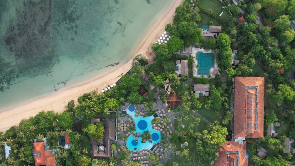 Luxury Bali resort with infinity pool overlooking tropical landscape and traditional architecture