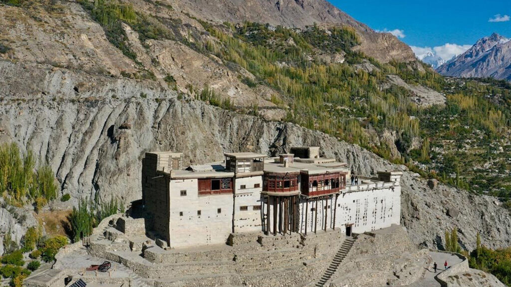 Ancient Baltit Fort in Karimabad showing traditional wooden architecture and stone construction against mountain backdrop