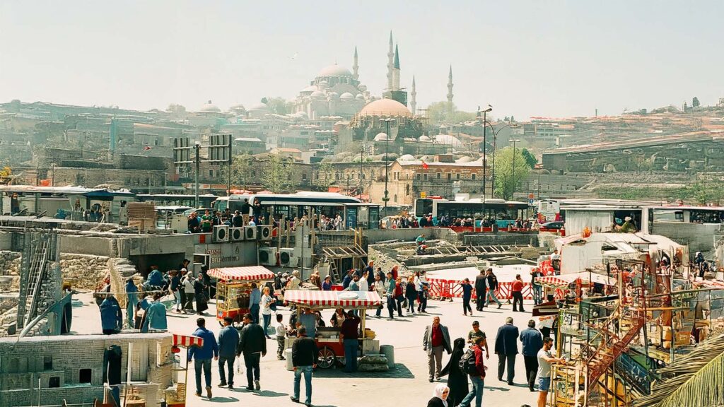 Tourist bargaining with shopkeeper at Grand Bazaar demonstrating traditional shopping culture