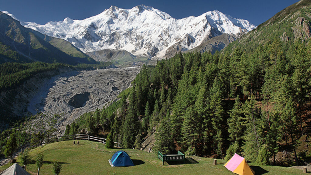 Trekkers at Rakaposhi Base Camp with Pakistan's 12th highest peak towering in the background