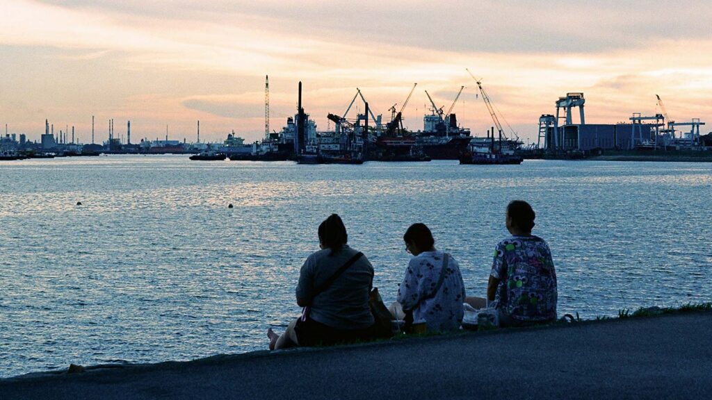 Summer scene on Bosphorus with pleasure boats and swimmers enjoying warm weather